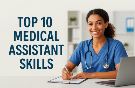 Medical assistant in scrubs working at a desk in a modern clinic, reviewing patient paperwork on a computer.