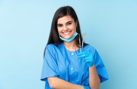 Dental Assistant holding tools