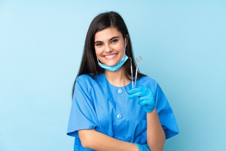 Dental Assistant holding tools
