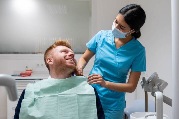 dental assistant with patient