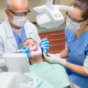 Dental assistant helping a dentist