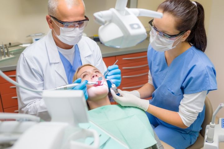 Dental assistant helping a dentist